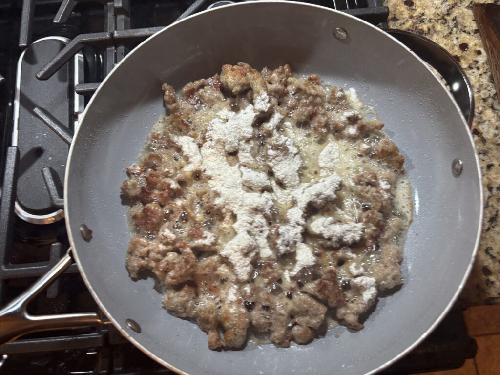 Adding flour to skillet to make roux for country gravy 
